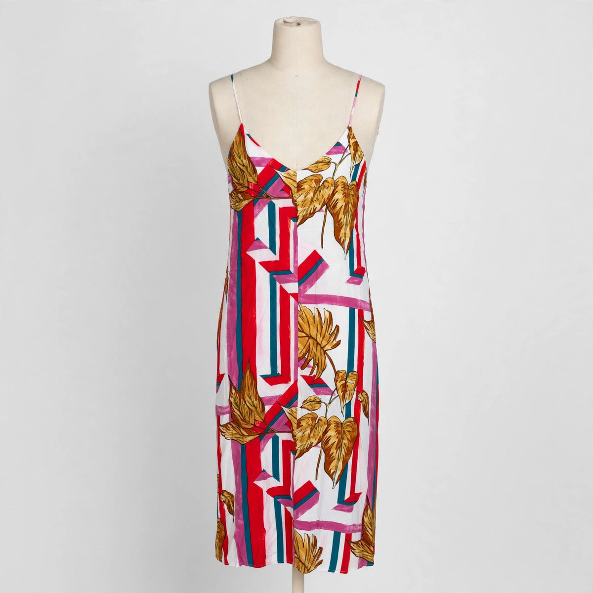 Lush striped leaf print slip dress on a dress form